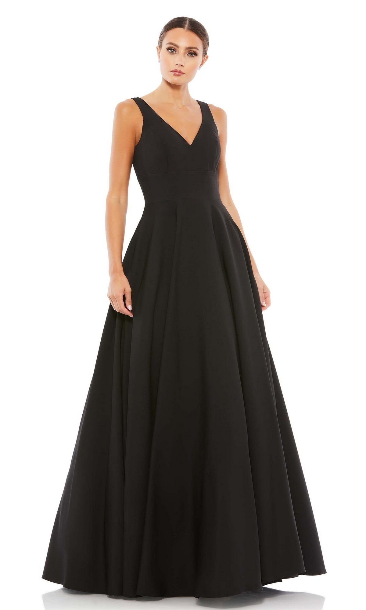 A woman models the Classic Long Prom Ball Gown: Mac Duggal 48924, a sleeveless V-neck floor-length dress, standing against a plain white background.